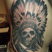 Skull in an indian headdress tattoo on ribs