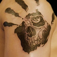 Skull in palmprints tattoo on shoulder