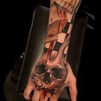 Skull with blood tattoo on hand by Daniel Melaniuk