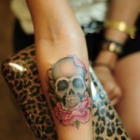 Skull with rose forearm tattoo design for women