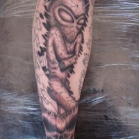 Sleeping alien tattoo on leg