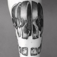 Sliced human skull pieces tattoo in engraving style with dotted work and volume details