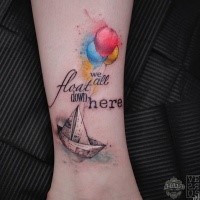 Small beautiful looking leg tattoo of paper ship with lettering and balloons