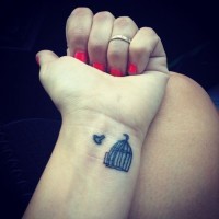 Small birds tattoo with cage on wrist