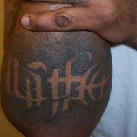 Small black ink ambigram tattoo of lettering
