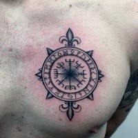 Small black ink chest tattoo of ancient compass with lettering