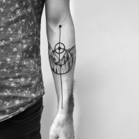 Small black ink forearm tattoo or circles with mountains