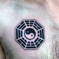 Small black ink Japanese traditional Yin Yang symbol tattoo on chest