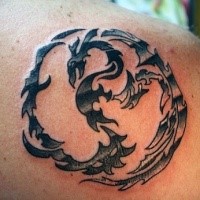 Small black ink shoulder tattoo of fantasy dragon