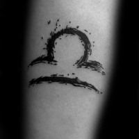 Small black ink symbol tattoo