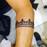 Small blackwork style arm tattoo of cool ornament