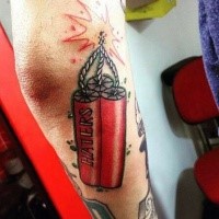 Small carton style arm tattoo of dynamite with lettering