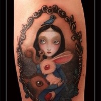 Small cartoon style arm tattoo of cute girl with birds and animals