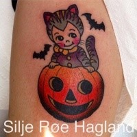 Small cartoon style arm tattoo of little kitten with pumpkin