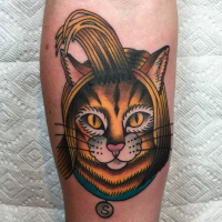 Small cartoon style colored cat face tattoo on forearm