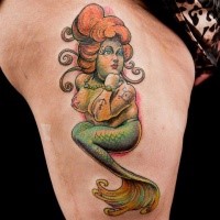 Small cartoon style colored thigh tattoo of little mermaid
