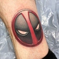 Small cartoon style tattoo of incredible Deadpool face