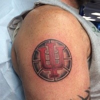 Small circle shaped basketball tattoo on shoulder with symbol