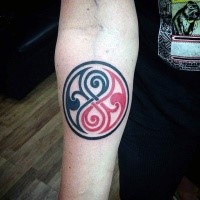 Small circle shaped interesting Celtic style tattoo on forearm