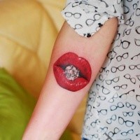 Small colored arm tattoo of red lips with diamonds