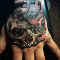 Small colored human skull tattoo stylized with puzzle pieces