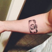 Small cool gray-ink camera tattoos on forearm