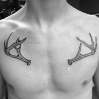 Small cute looking chest tattoo of deer horns