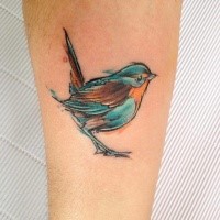 Small cute looking watercolor style leg tattoo of small bird