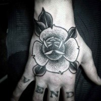 Small dotwork style hand tattoo of cute flower