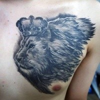 Small gray washed style chest tattoo of lion head with crown