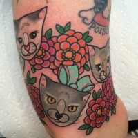 Small illustrative style colored arm tattoo of cute kittens with flowers