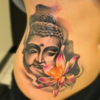 Small illustrative style colored side tattoo of Buddha statue and lotus flower