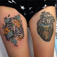 Small illustrative style thigh tattoo of human skeleton and heart