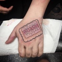 Small interesting looking hand tattoo of little cookie