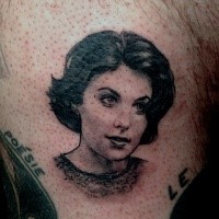 Small medium size tattoo on woman portrait