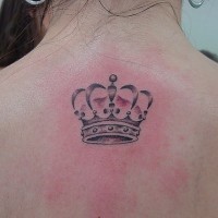 Small realistic crown tattoo on upper back