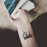 Small size open book tattoo on wrist