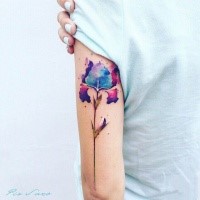 Small watercolor style arm tattoo of little flower