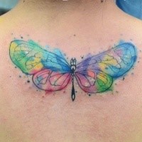 Small watercolor style colored butterfly tattoo on upper back