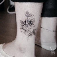 Small Zihwa typical ankle tattoo of flowers with moon