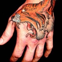 Snarling tiger head tattoo on hand