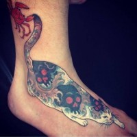 Sneaking cat with unusual color tattoo on leg