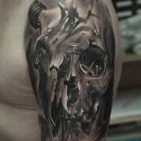 Spectacular black and white shoulder tattoo of human skull