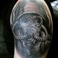 Spectacular black ink shoulder tattoo of soldier in gas mask