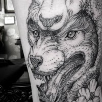 Spectacular black ink wolf in sheep's clothing tattoo stylized with flowers