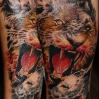Spectacular colored evil lion head tattoo on forearm