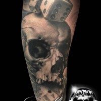 Spectacular designed and painted big detailed skull with dice and playing cards tattoo on arm