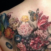 Spectacular lifelike colored various flowers tattoo on back with butterfly