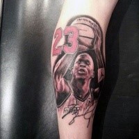 Spectacular looking colored Michael Jordan with red number tattoo on arm