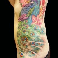 Spectacular looking colorful illustrative style large side tattoo of peacock with flowers